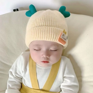 Cute yellow baby winter knit hat with green heart accent and sun patch ear protection