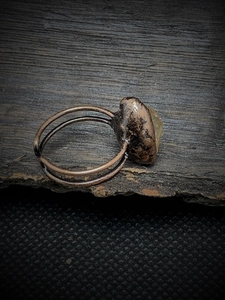 Macro shot of vintage adjustable copper ring with raw yellow natural gemstone detail