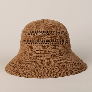 Close-up of brown knitted sun hat showing dense weave texture and hollowed-out pattern