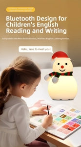 Detail showing Asian girl reading near snowman night light with Bluetooth speaker