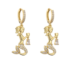 Detailed close-up of gold mermaid earrings with micro-paved zircons and teardrop crystals