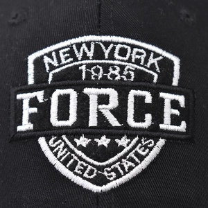 Black cotton baseball cap featuring Force shield embroidery and New York 1985 text