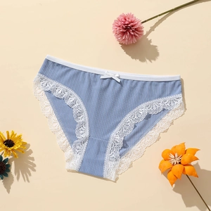 Blue low-waist ribbed polyester panties with white lace trim and bow on beige background
