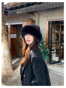 Close-up detail of fluffy faux fur bucket hat in black with premium plush texture