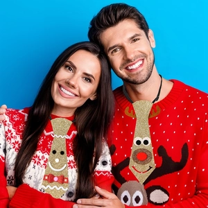 Detail of felt Christmas ties featuring cartoon gingerbread man and reindeer designs