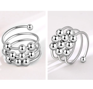 Macro view of adjustable silver fidget ring with three layers and movable beads