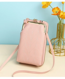 Detailed view of pink PU leather crossbody bag with V-quilted texture and gold metal clasp