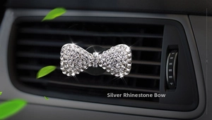 Close-up of a silver rhinestone bow car air vent clip with glittering crystal details