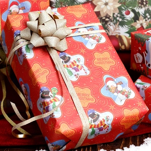 Red Christmas wrapping paper featuring cartoon snowmen and golden glitter ribbon