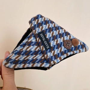Detail of triangle claw clip with plaid fabric, handmade label and vintage button