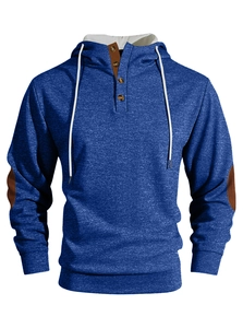 Detail of blue corduroy sweatshirt featuring button collar and brown elbow patches