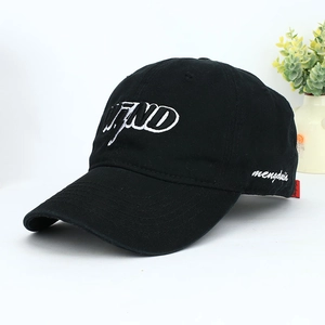Close-up of black cotton baseball cap featuring bold WEND white embroidery detail