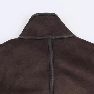 Detailed view of brown suede jacket collar with leather trim and precision stitching