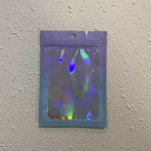 Detail of purple resealable pouch with holographic laser window and hanging hole