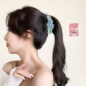 Chic iridescent acrylic floral banana hair clip shown in a stylish high ponytail style