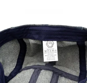 Detailed macro view of 100% cotton denim ivy cap inner care label and stitching