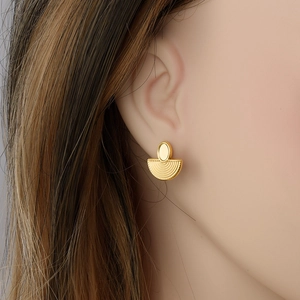 Elegant gold 304 stainless steel fan-shaped earrings worn by a model in natural light