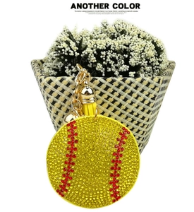 Macro shot of baseball keychain with yellow rhinestones, red stitching and tassel