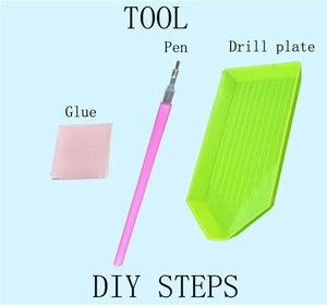 Macro view of DIY diamond painting tool set with pen, pink glue, and green drill tray