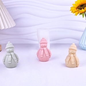 Silicone snowman candle mold with finished crafts featuring knitted hat and scarf textures