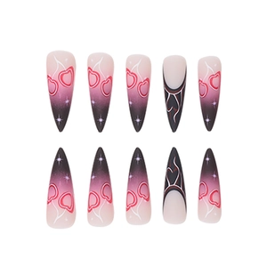 Macro view of long stiletto press-on nails featuring cherry art and heart flame design