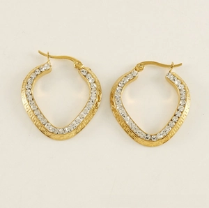 Detail of gold-plated heart earrings featuring Greek key pattern and cubic zirconia