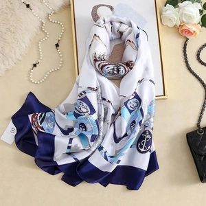 Detail of nautical silk scarf with anchor patterns styled with pearls and roses