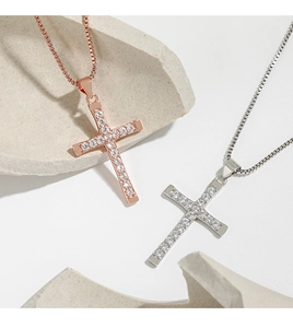 Detail of cross pendants in rose gold and silver with pave set cubic zirconia stones