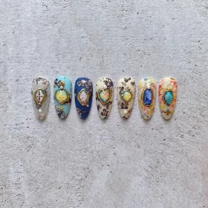Floral press-on nails with vintage gold frames and colorful gemstone accents