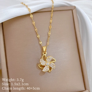 Detail view of rotating windmill necklace with size, weight, and chain length dimensions