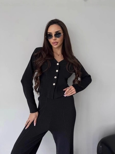 Women's black knit two-piece set featuring a V-neck button cardigan and high-waist trousers