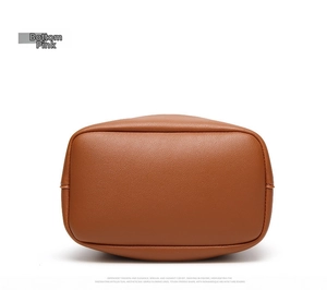 Detailed view of the brown PU leather bucket bag bottom with refined stitching