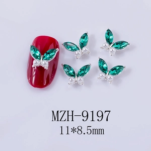 Detail of 11x8.5mm green marquise butterfly nail charms with white pearls and alloy base