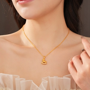 Close-up of gold-plated rocking horse pendant with sparkling crystals on a fine chain