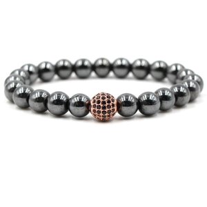 Detailed shot of dark grey hematite beads with a rose gold accent and black gemstone
