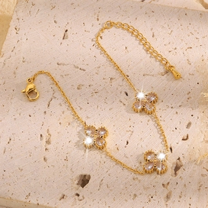 Elegant gold four-leaf clover bracelet with sparkling pear-cut zircon pendants for women