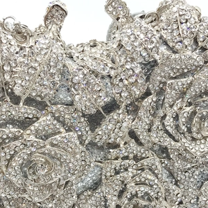 Macro shot of silver rhinestone floral patterns on luxury evening clutch handbag