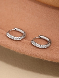 Macro shot of silver-colored hoop earrings with double-row micro-pave cubic zirconia