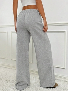 Rear view of grey ribbed knit wide-leg pants showing the soft texture and relaxed drape