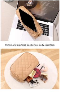 Detail view of beige quilted makeup bag with gold zipper and spacious inner storage