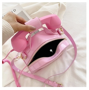Detail view of the main pocket interior for pink vintage phone shaped crossbody bag