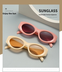 Detail view of pink and beige oval polarized sunglasses with thick frames and UV protection