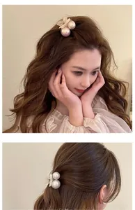 Detail showing elegant pearl and petal hair claw clip worn on front and back by model