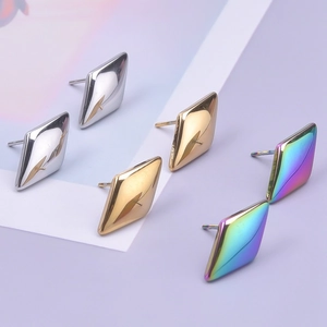 Detailed view of geometric diamond stud earrings in silver, gold, and rainbow finish
