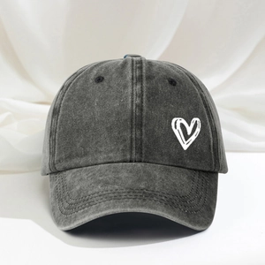 Adjustable washed charcoal baseball cap featuring an embroidered white heart pattern
