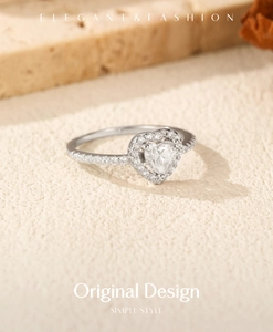 Macro shot of S925 silver ring featuring heart-cut moissanite and micro-pave diamond setting