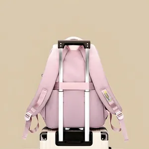 Pink travel backpack with luggage strap on suitcase handle for student commuting