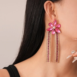 Macro view of vintage floral tassel earrings with pink crystals and long rhinstone fringes