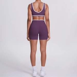 Deep purple two-piece yoga set with contrasting white trim and high-waisted shorts