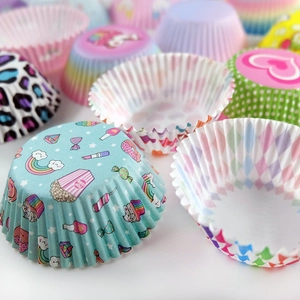 Macro shot of assorted greaseproof muffin cups with colorful patterns and prints